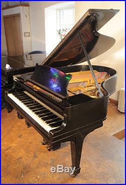 A 1922, Steinway Model O grand piano with a black case and spade legs
