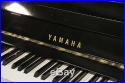 A 1971, Yamaha Upright Piano with a Black Case and Brass Fittings