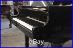 A 1974, Yamaha G2 grand piano with a black case and spade legs. 3 year warranty