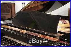 A 1974, Yamaha G2 grand piano with a black case and spade legs. 3 year warranty