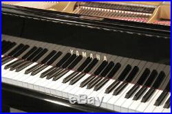 A 1974, Yamaha G2 grand piano with a black case and spade legs. 3 year warranty