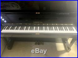 A 1981, Yamaha U1 upright piano with a black case in Excellent condition
