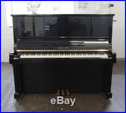 A 1983, Yamaha UX-3 upright piano for sale with a black case and brass fittings