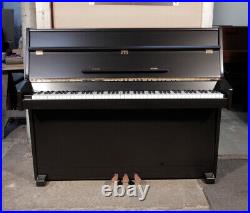 A 1988, Young Chang Upright Piano with a Satin Black Case and Brass Fittings