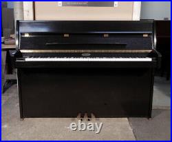 A 1995, Kemble Upright Piano with a Black Case and Brass Fittings