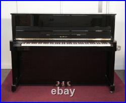 A 2000, Kawai CX-5H upright piano with a black case