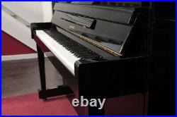 A 2000, Kawai CX-5H upright piano with a black case