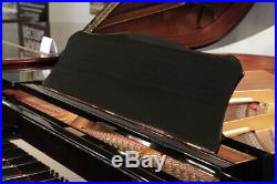 A 2003, Yamaha C2 grand piano with a black case and spade legs