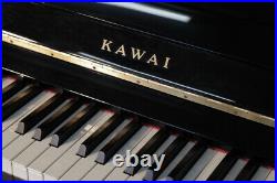 A 2006, Kawai K-15E upright piano with a black case. 3 year warranty