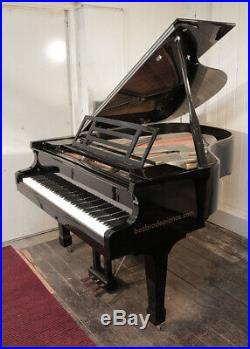 A 2010, Feurich Model 178 grand piano with a black case and gun metal frame