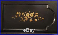 An 1886 Steinway upright piano with a satin, black case and floral inlaid panels