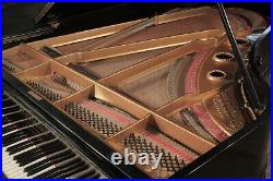 An 1896, Schiedmayer grand piano with a black case, filigree music desk and turn