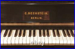 An 1897, Bechstein upright piano with a black case and striking floral inlay