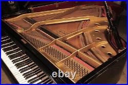 Apollo grand piano with a polished, black case and brass fittings