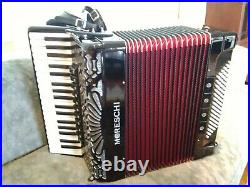 Moreschi accordion, overall black and red inner folds with carry case