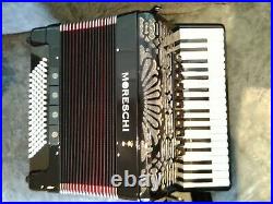 Moreschi accordion, overall black and red inner folds with carry case