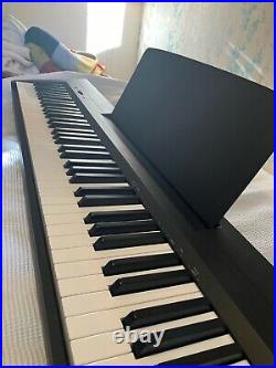 Pre-loved Yamaha P-145 digital piano with foot pedal, stand, books and soft case