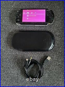 Sony PSP 2003 console Piano Black, 32gb memory card, USB cable & leather case