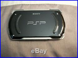 Sony PSP Go Launch Edition 16GB Piano Black Handheld System, Charger, Case, Games