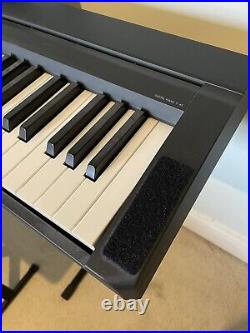Yamaha P-45B digital piano with stand, stool, foot pedal, carry case, and books