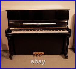 Young Chang E-118 Upright Piano with a Black Case and Brass Fittings