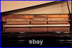 Young Chang E-118 Upright Piano with a Black Case and Brass Fittings